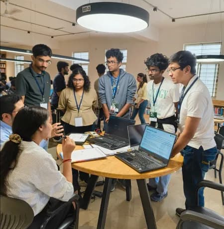 Judges evaluating campus hackathon projects against criteria